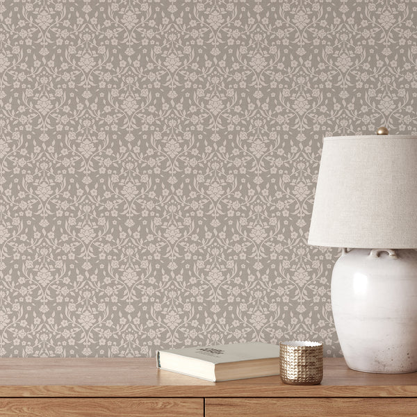 Beige floral damask wallpaper featuring cream-colored flowers, flowing botanical vines and delicate leaves on a warm taupe background with subtle texture.