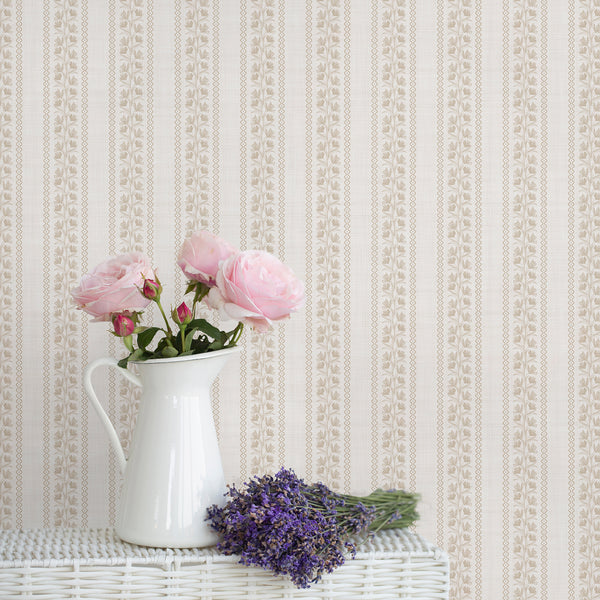 Soft beige floral stripe wallpaper with delicate white botanical vines creates a vintage cottagecore look, perfect for nurseries, bedrooms, bathrooms, and French country interiors.