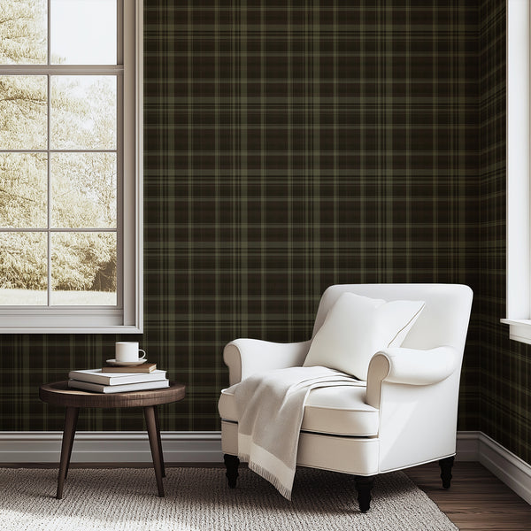 Dark olive green plaid wallpaper featuring a vintage tartan check pattern with black, forest green, and muted earthy tones for a moody bedroom accent wall.