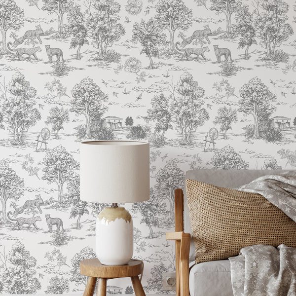 Gray French toile safari wallpaper featuring finely engraved scenic vignettes with leopards, birds, and countryside details on a white ground. Ideal for traditional or eclectic interiors, this removable wallpaper adds a sophisticated statement to bedrooms or dining rooms.