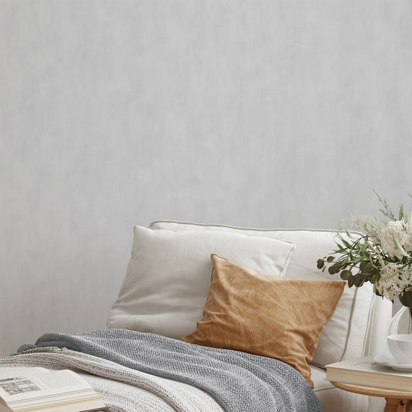 Light gray plaster look wallpaper with soft mottling, ideal for minimalist interiors in living rooms and bedrooms.