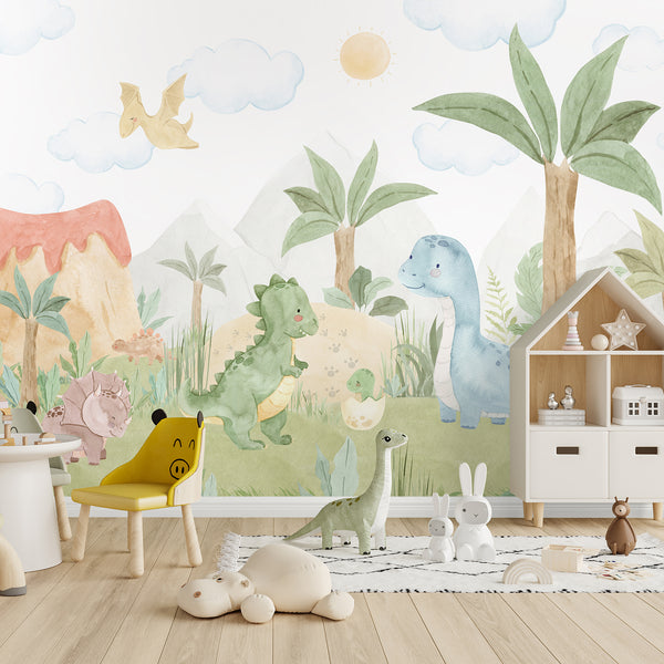 Watercolor dinosaur wallpaper mural with cute green and blue dinos, palm trees, mountains and clouds for a playful nursery or kids bedroom.