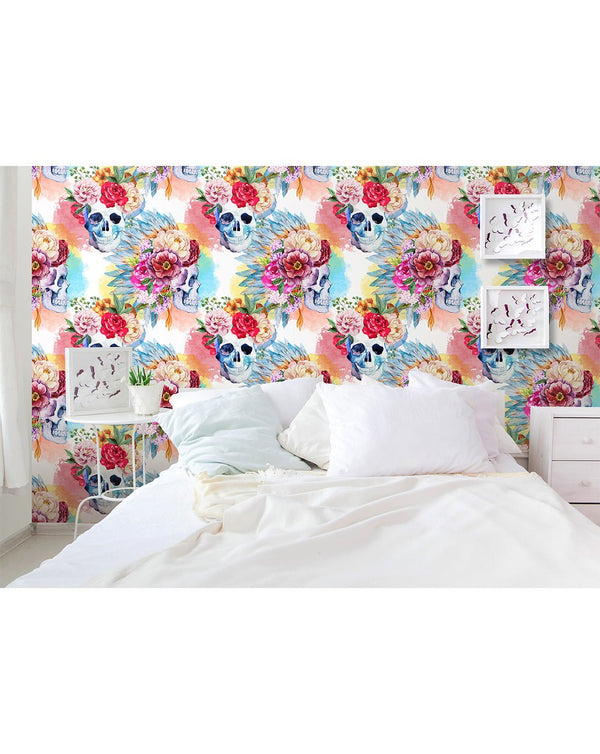 Colorful skull wallpaper with painterly blooms in rich magenta and yellow, set on a pastel blue backdrop. Ideal for a boutique space seeking a bold yet elegant gothic theme.